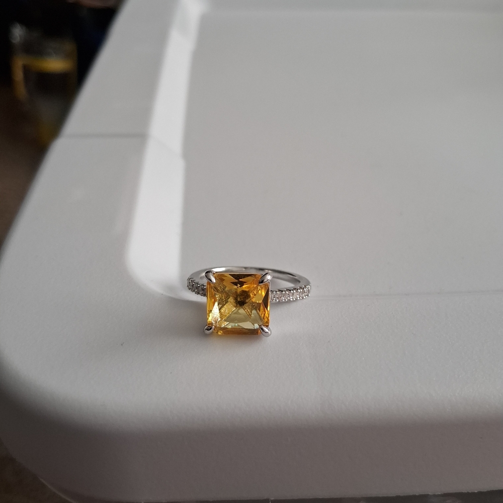Elegant Silver Tone Ring with Yellow Gemstone